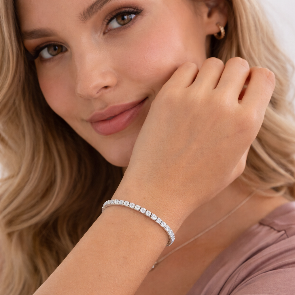 Woman wearing a Aura silver bracelet with a neutral background