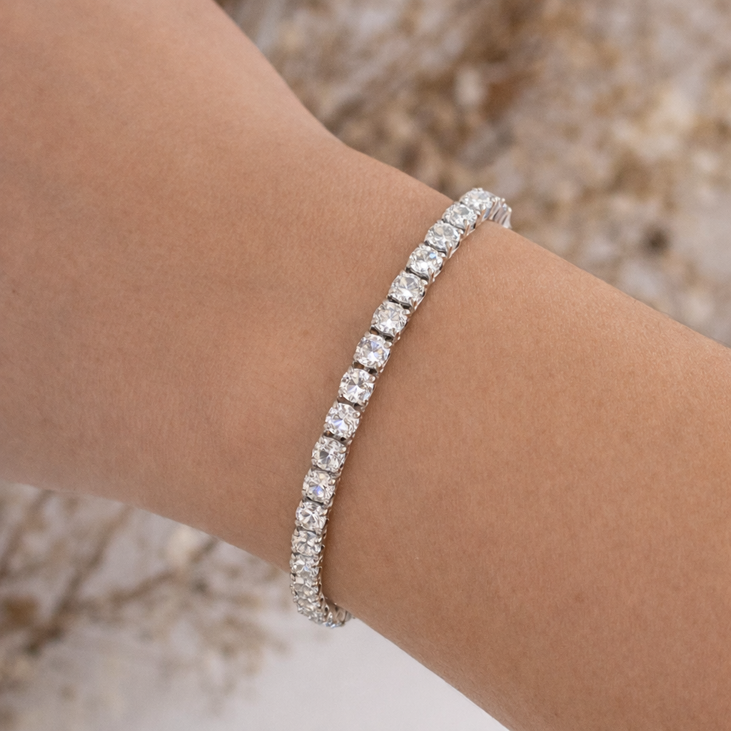 Silver bracelet with clear stones on a wrist