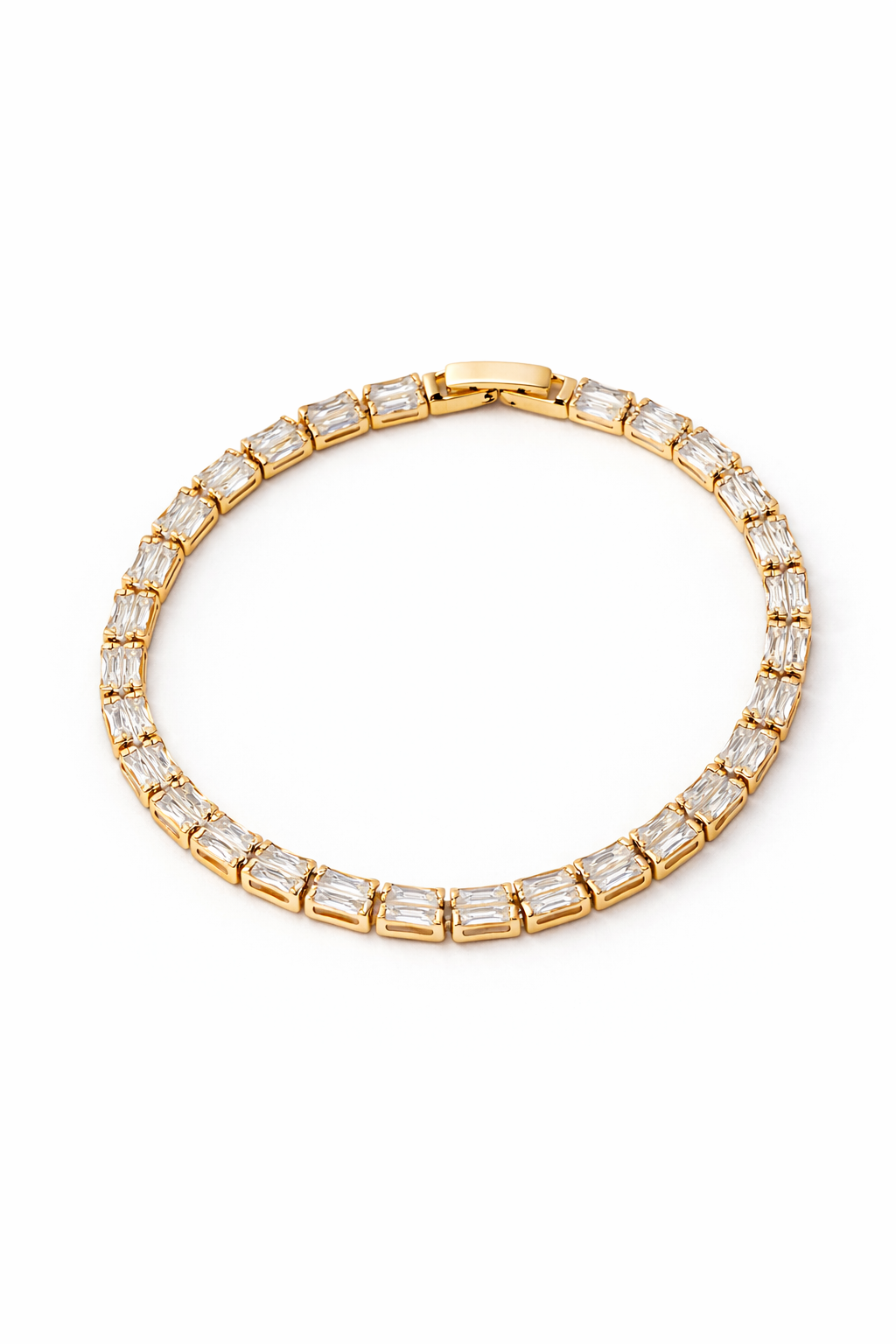 Gold tone bracelet with clear gemstones on a white background