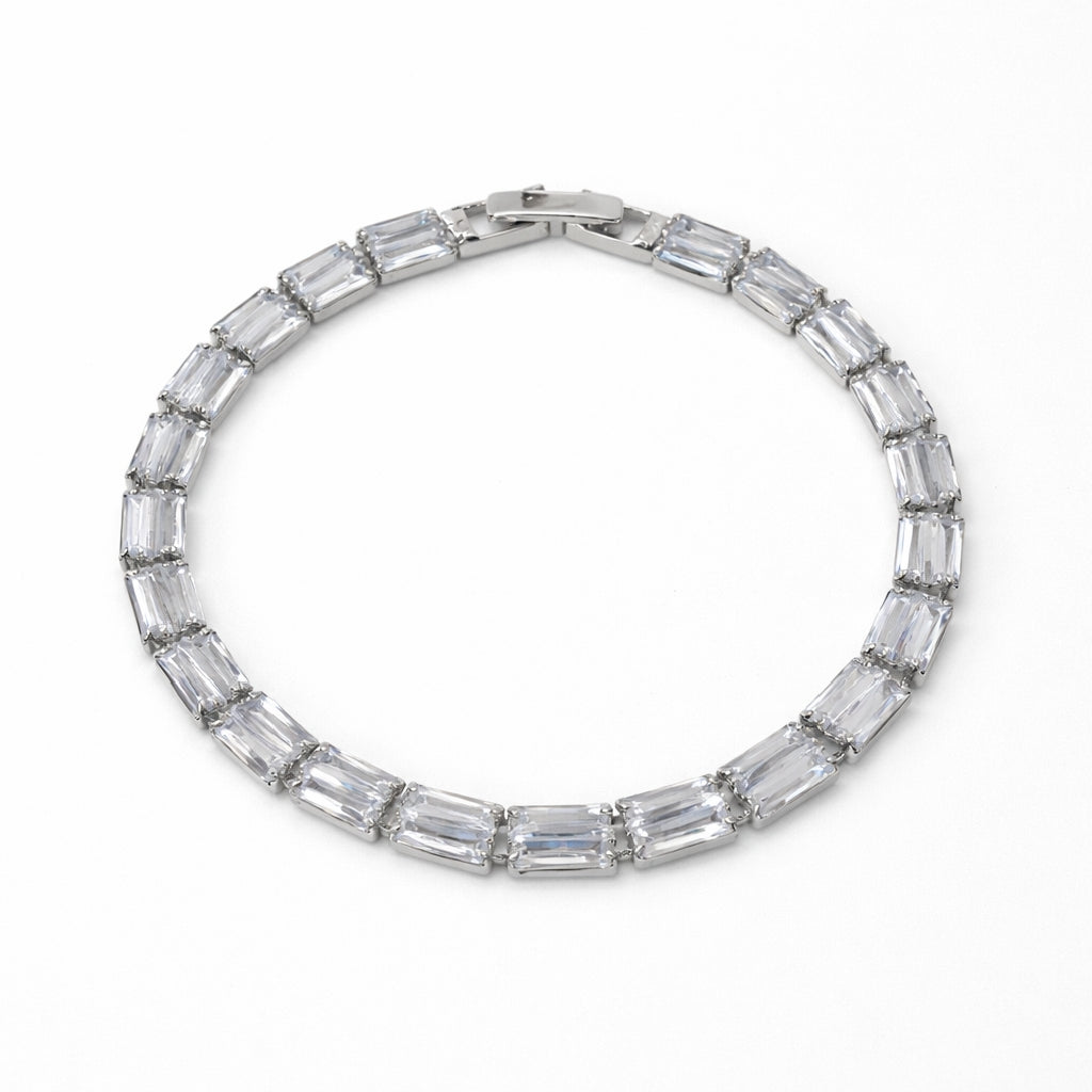 Silver bracelet with baguette-shaped crystals on a white background