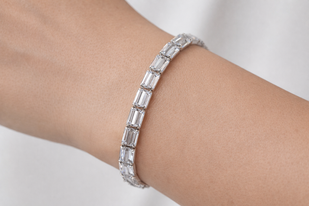 Silver bracelet with clear stones on a wrist against a white background