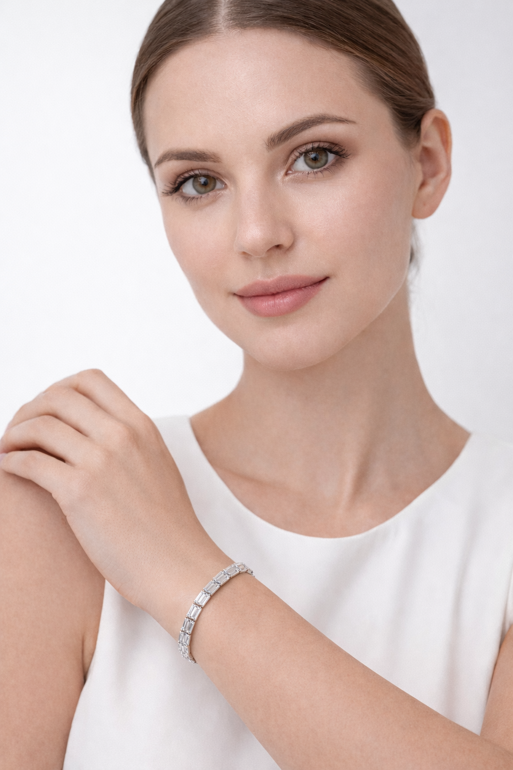 Woman wearing a silver bracelet on a white background