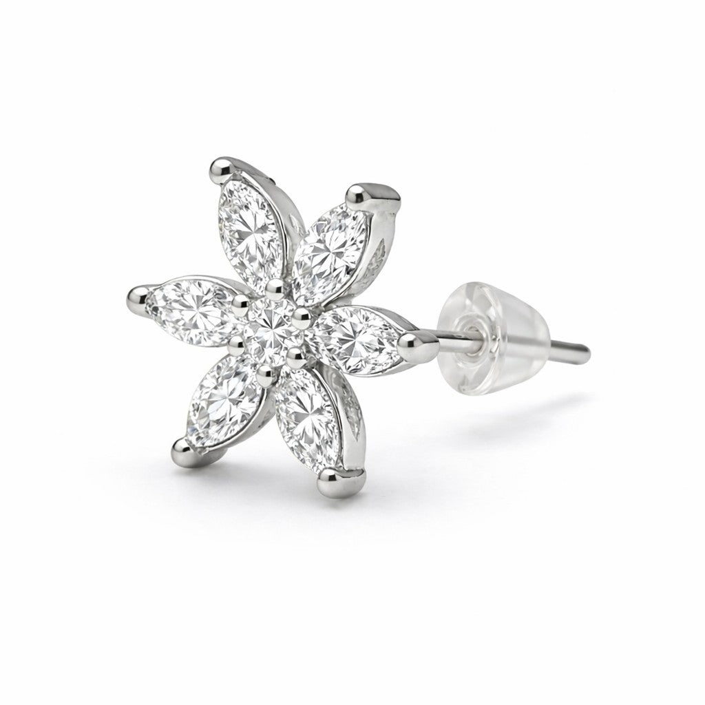 Silver flower-shaped earring with clear gemstones on a white background