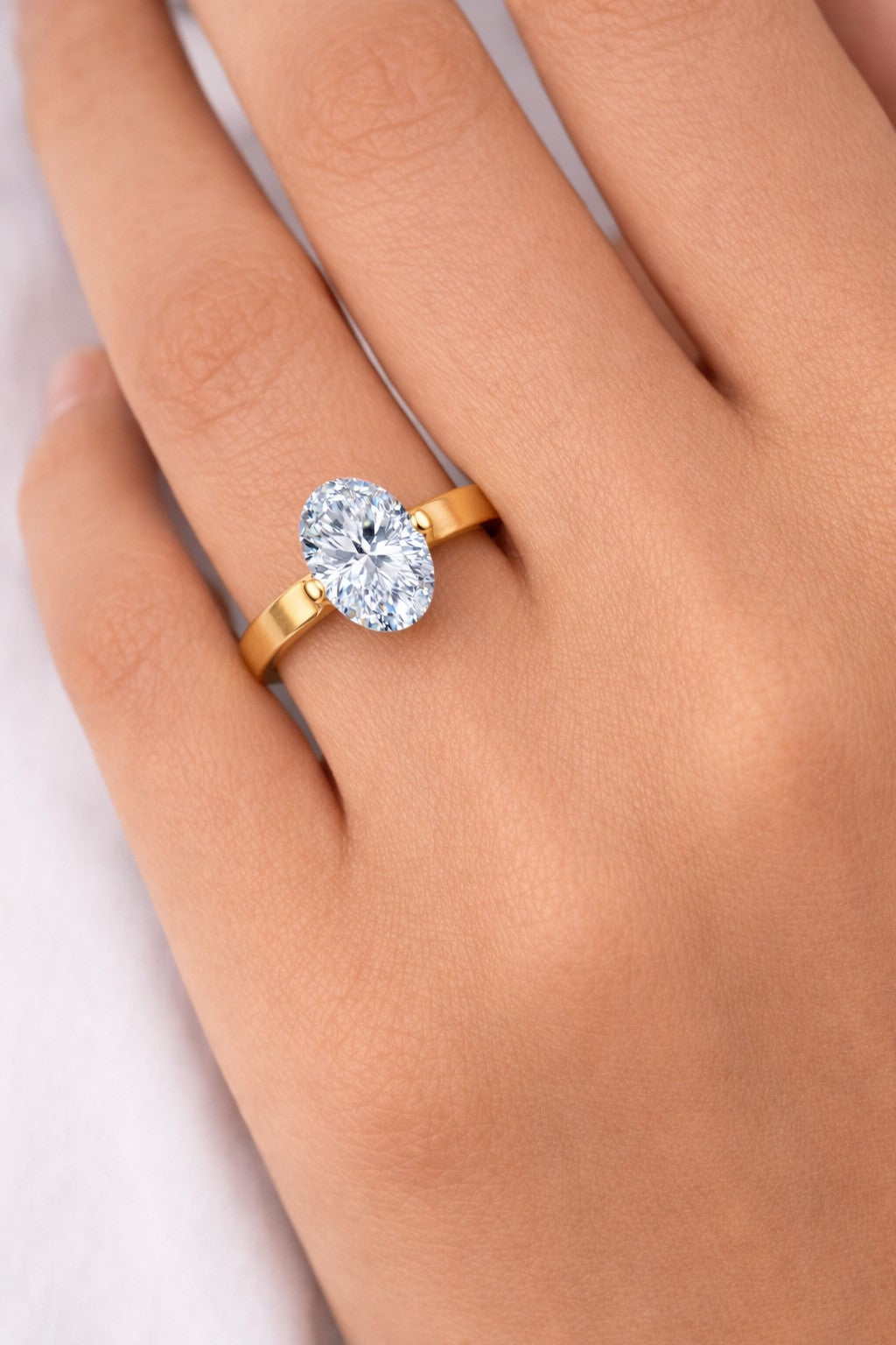 Close-up of rings for women with a gold-tone solitaire design on hand
