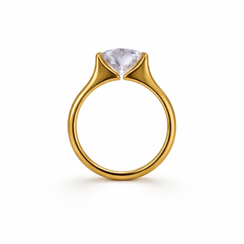 Gold-tone ring with a clear gemstone on a white background