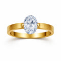 Gold-tone ring with a large diamond on a white background