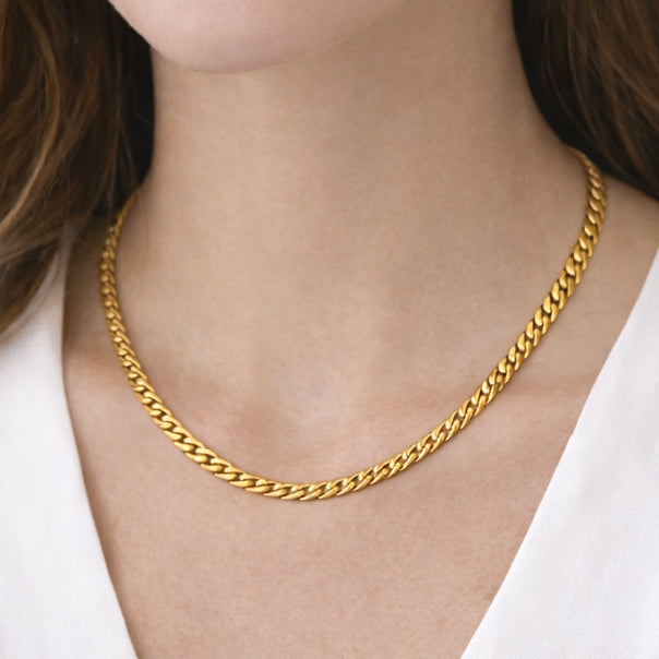 Close-up of necklaces for women with gold-tone chain design on neckline