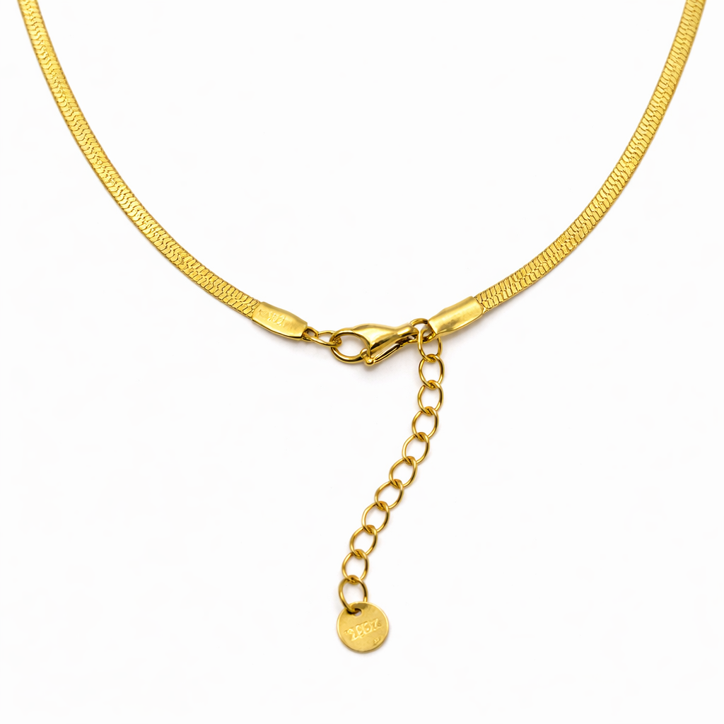 Chain detail of pendant necklace with gold-tone finish