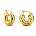 Pair of gold hoop earrings on a white background