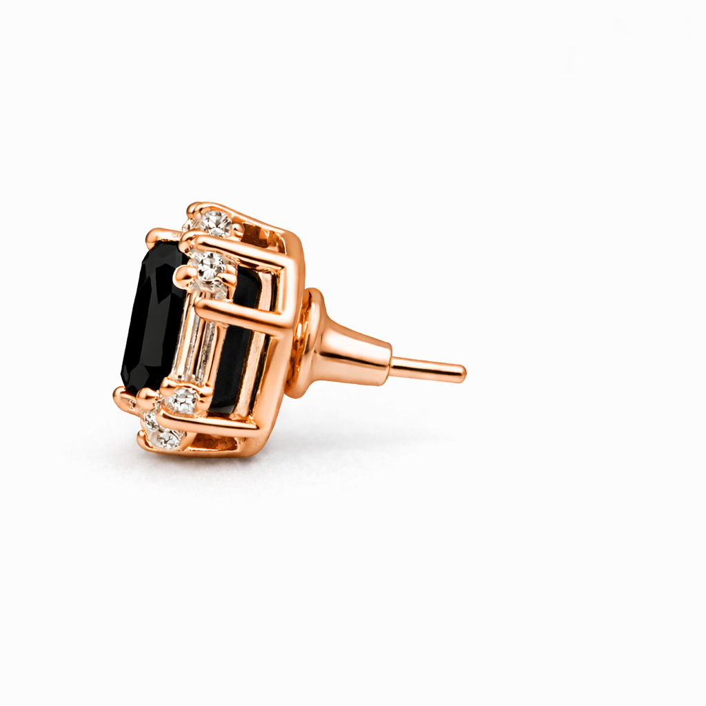 Rose gold earring with black gemstone on a white background