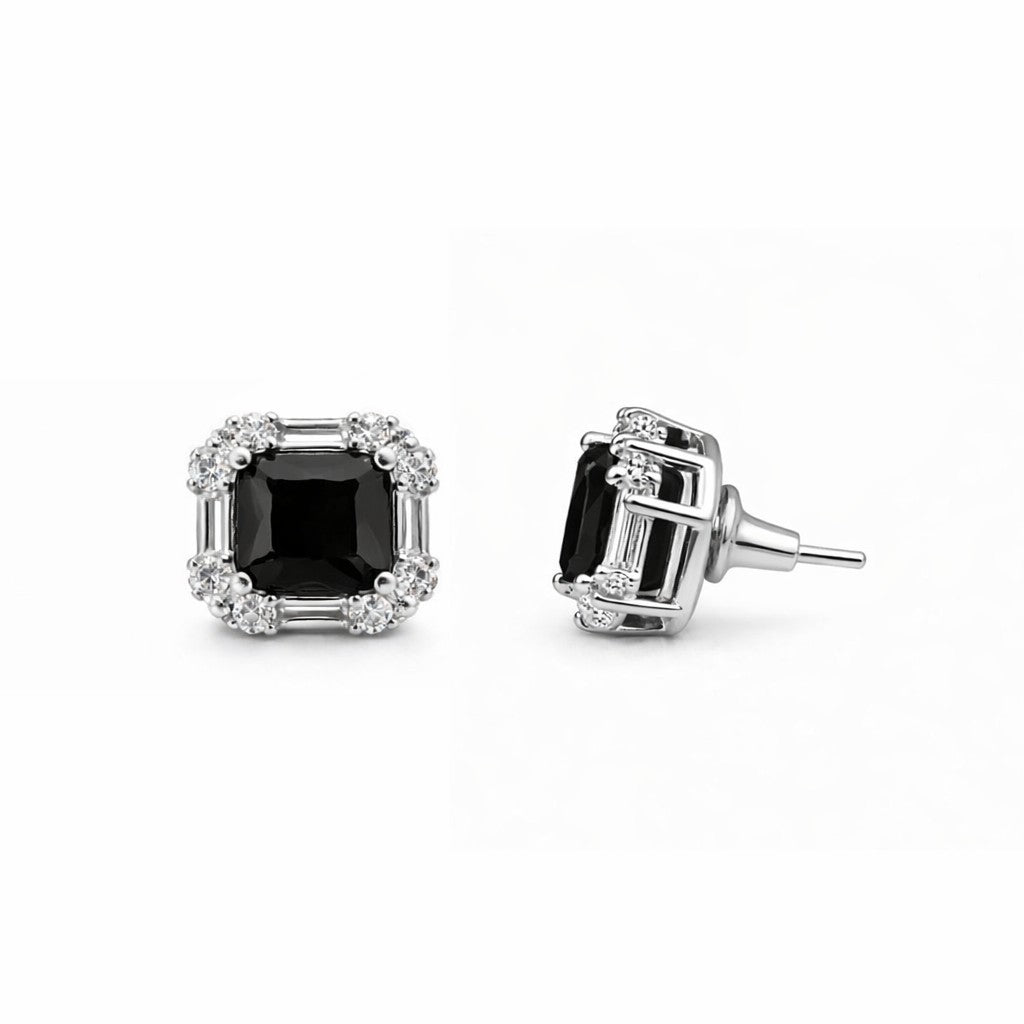 Pair of black stud earrings for women on white background