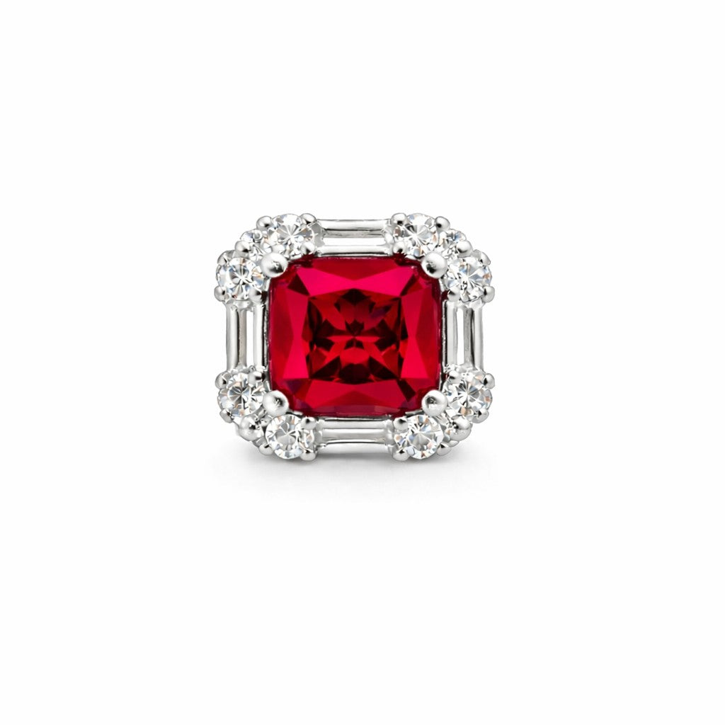 Red gemstone earring with silver frame on a white background