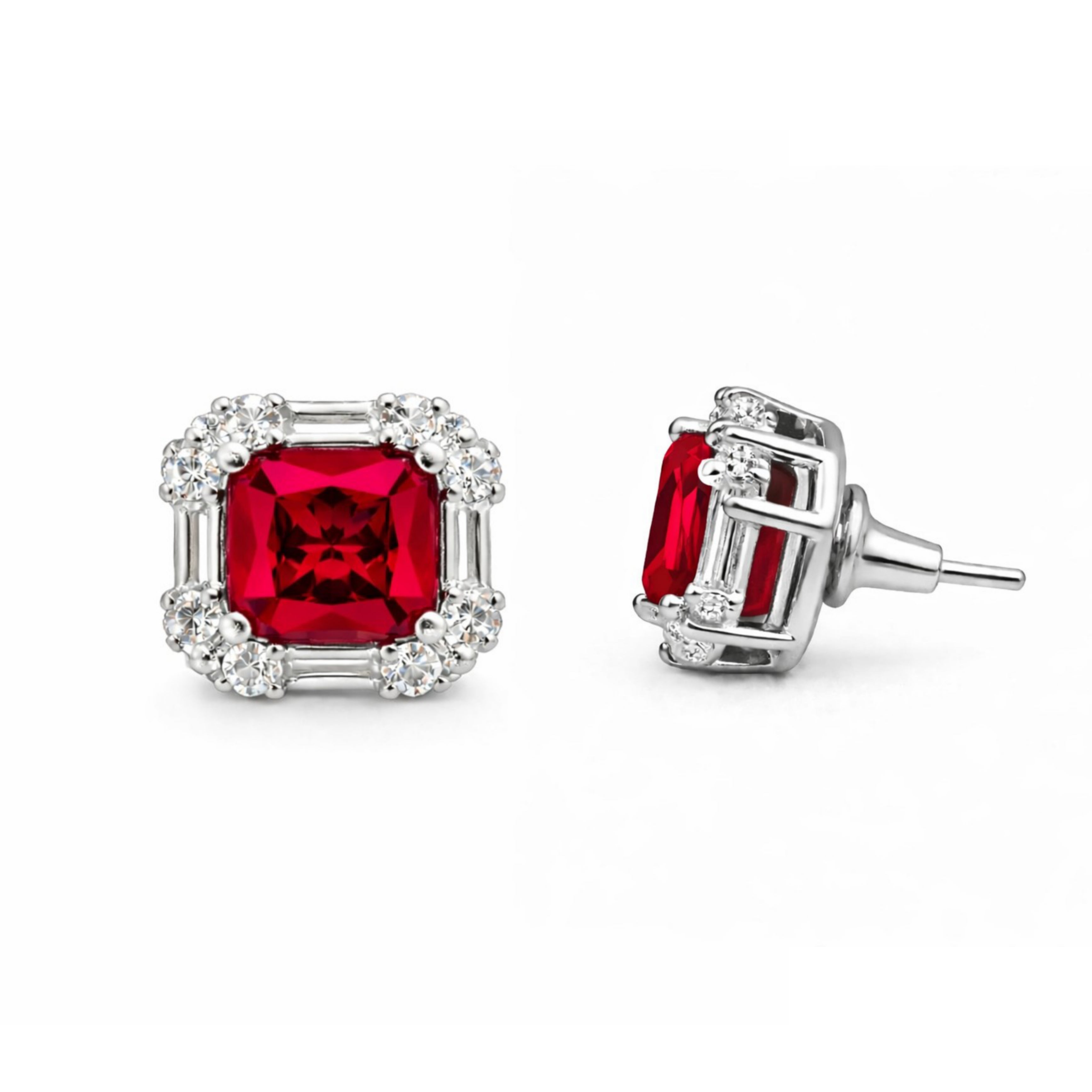 Pair of earrings with red gemstones and silver settings on a white background