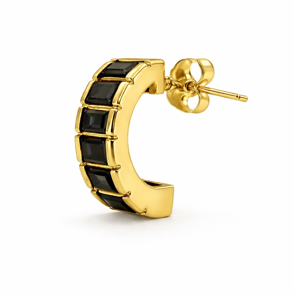 Gold hoop earring with black gemstones on a white background