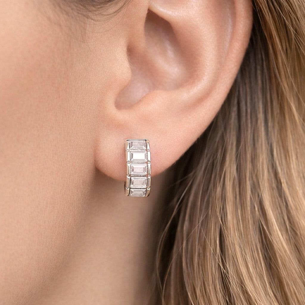 Silver hoop earring worn by a pakistani women with light brown hair.