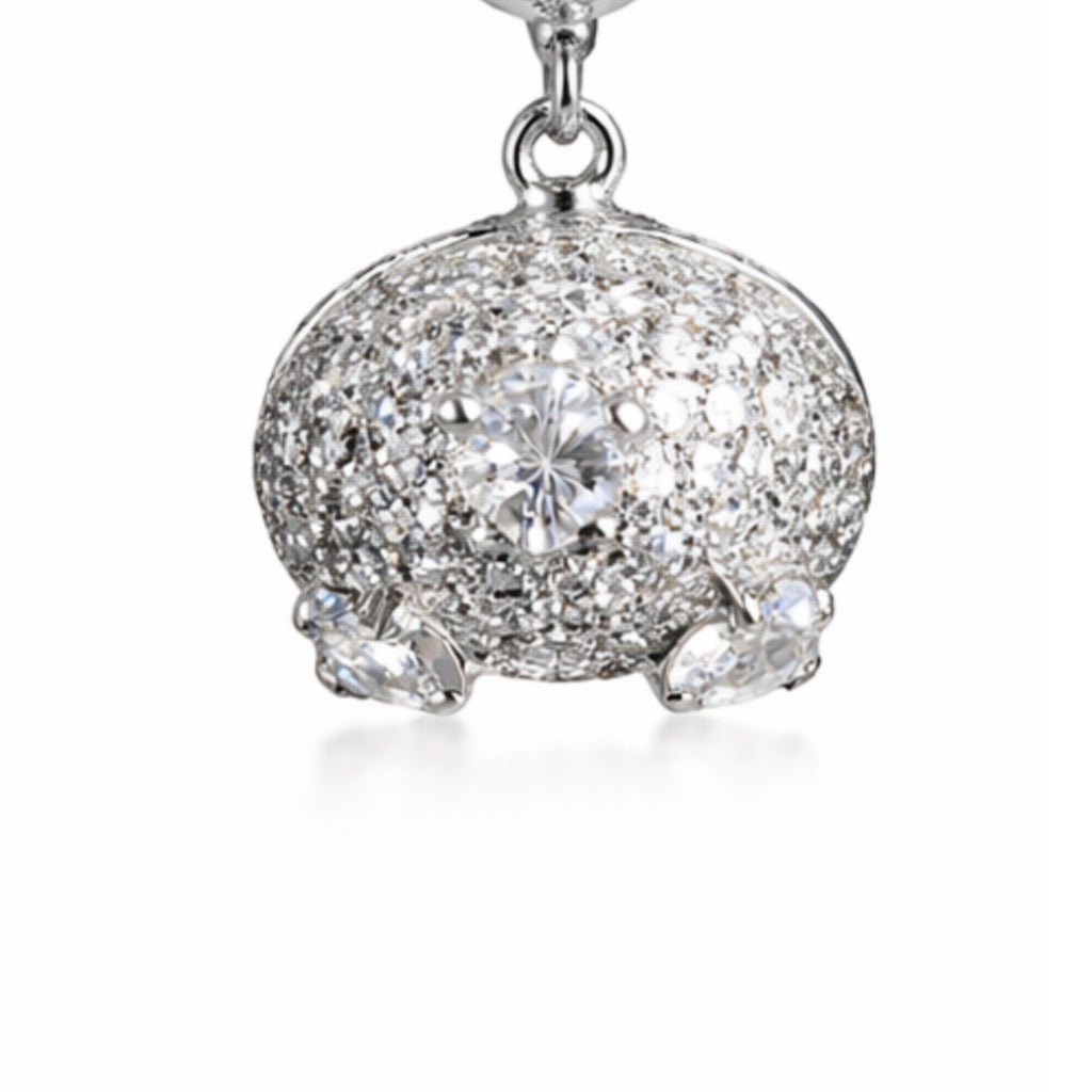 Silver earring with clear gemstones on a white background