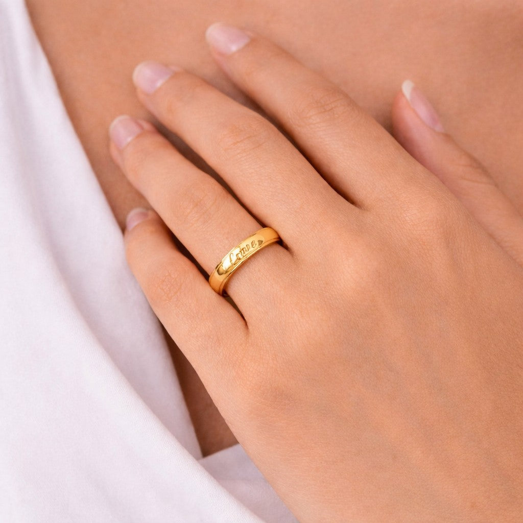 Gold-tone ring on a women finger with a soft focus background