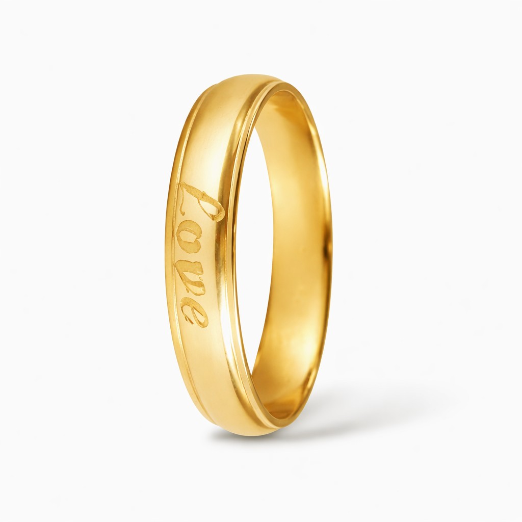 Gold-tone ring with 'love' engraving on a white background