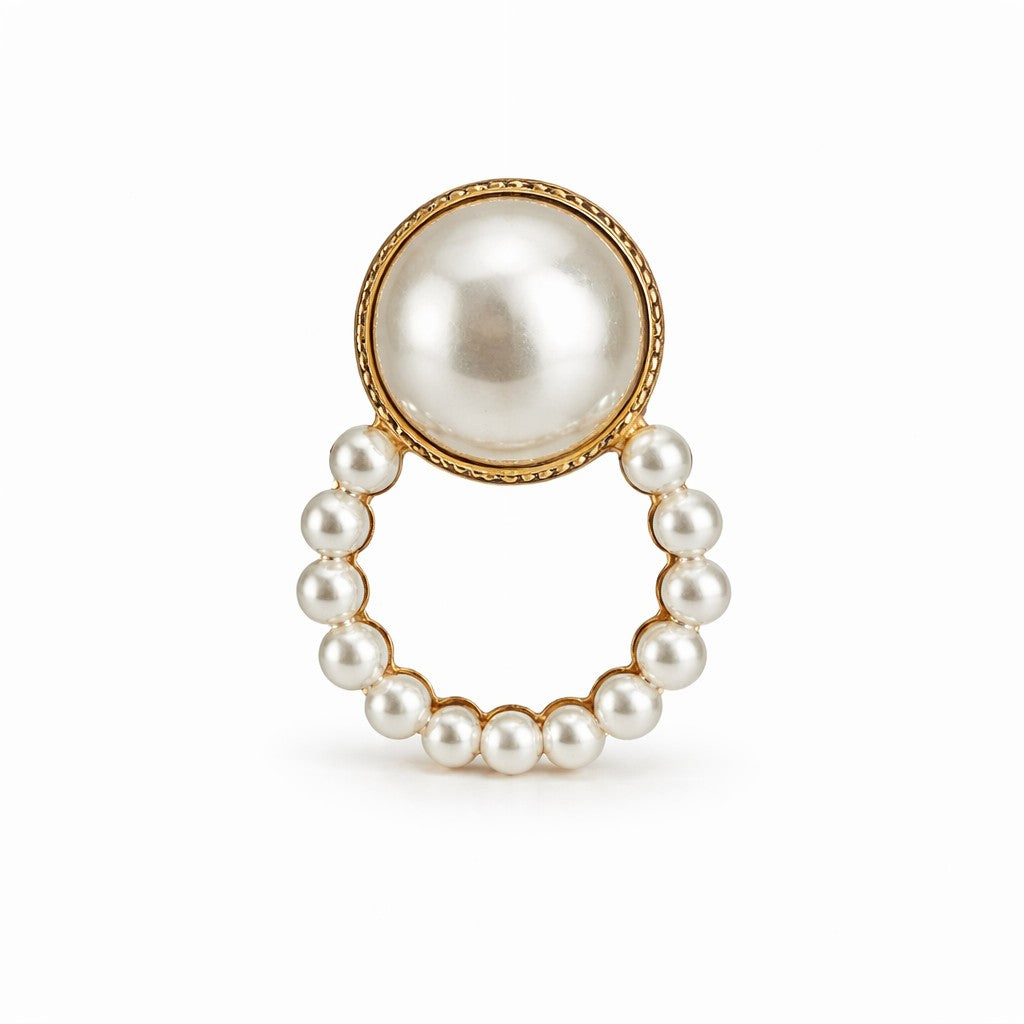 Pearl ring with gold accents on a white background