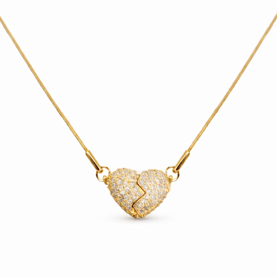 Front view of pendant necklace with gold-tone heart charm and stone detail