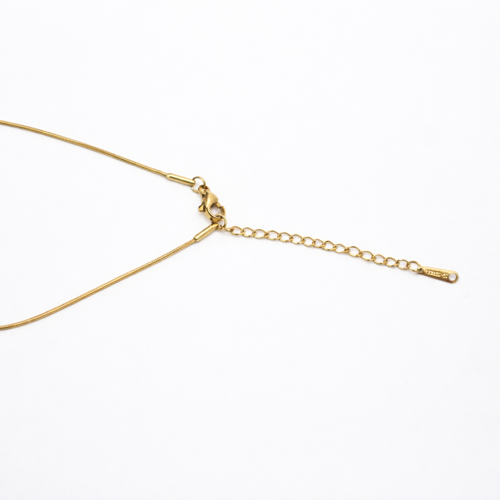 Chain detail of necklace with detachable gold-tone heart pendant