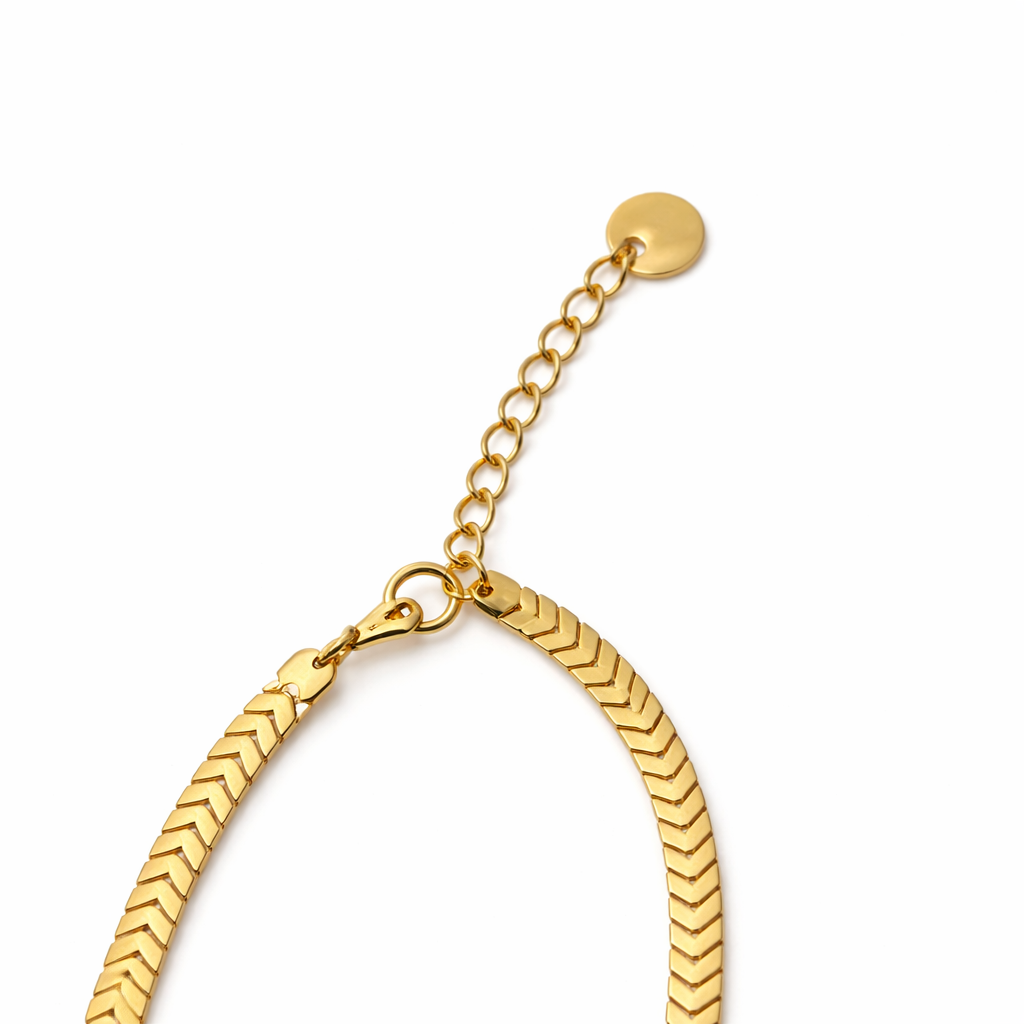 Close-up of chain necklace with flat polished gold-tone links