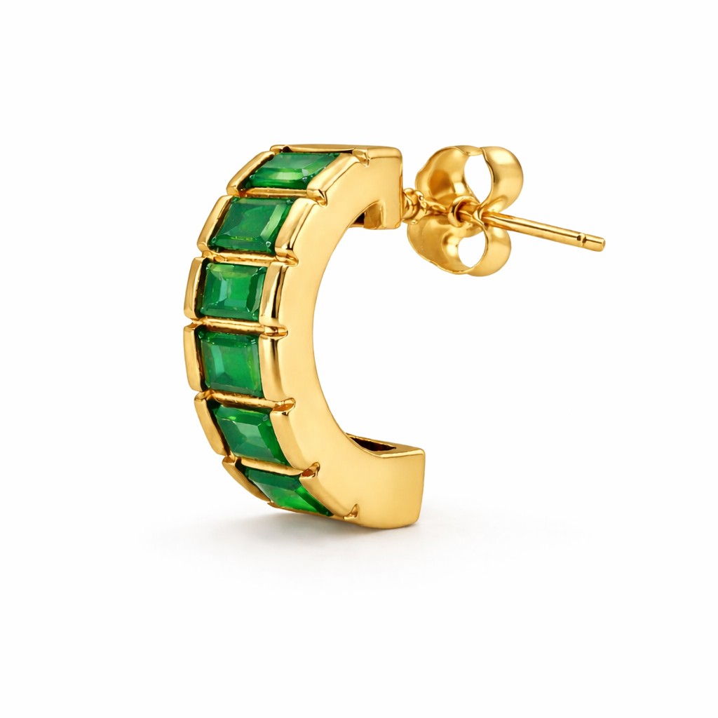 Gold hoop earring with green gemstones on a white background