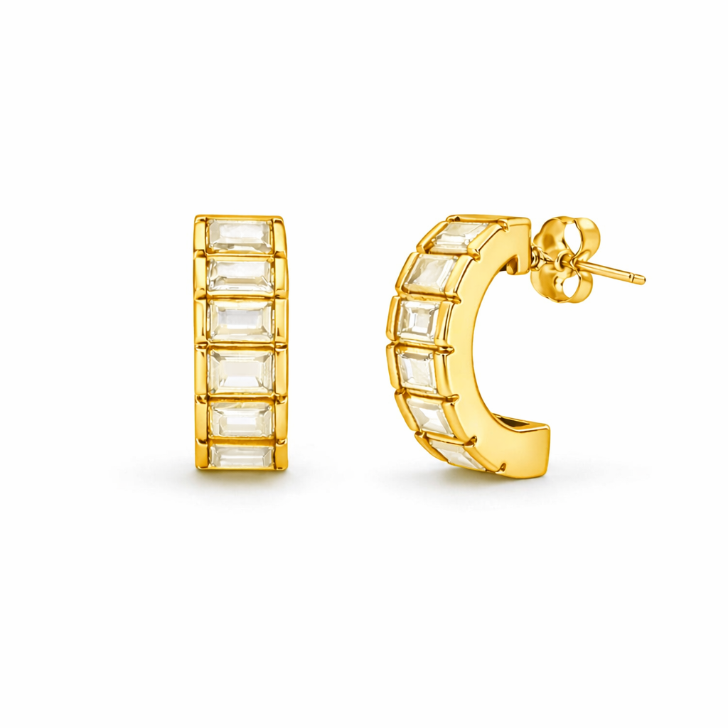 Gold hoop earrings with clear gemstones on a white background