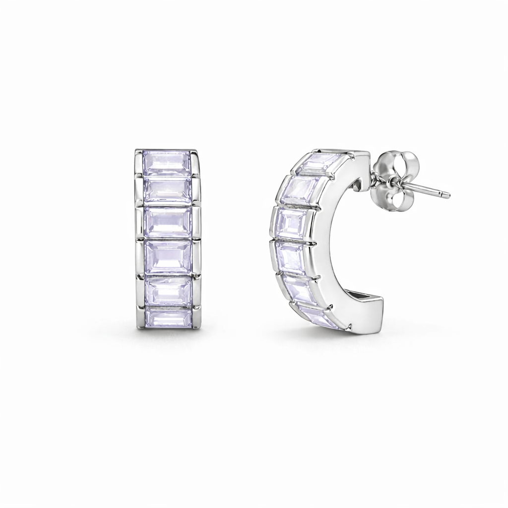Pair of silver hoop earrings with clear gemstones on a white background