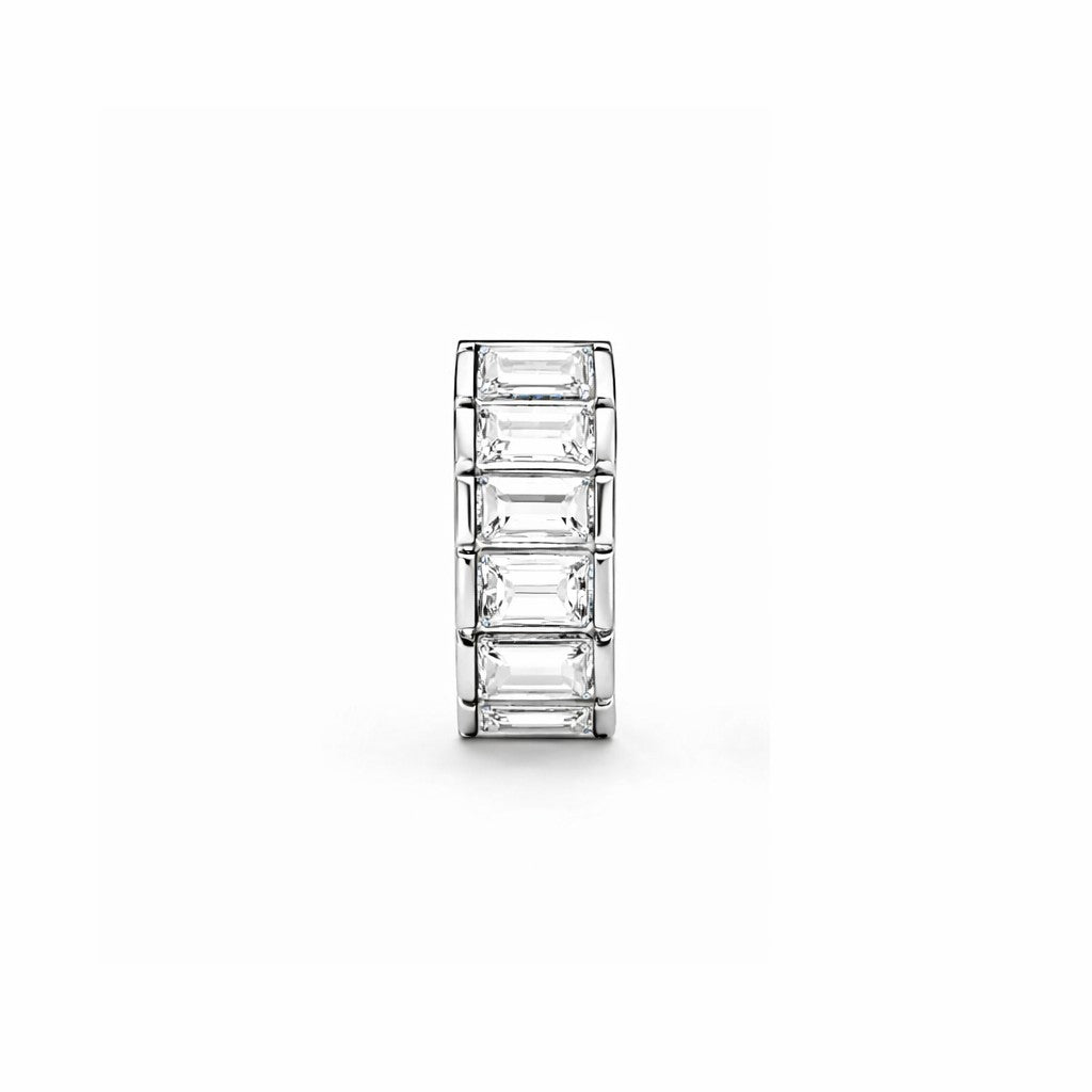 Silver ring with rectangular gemstones on a white background