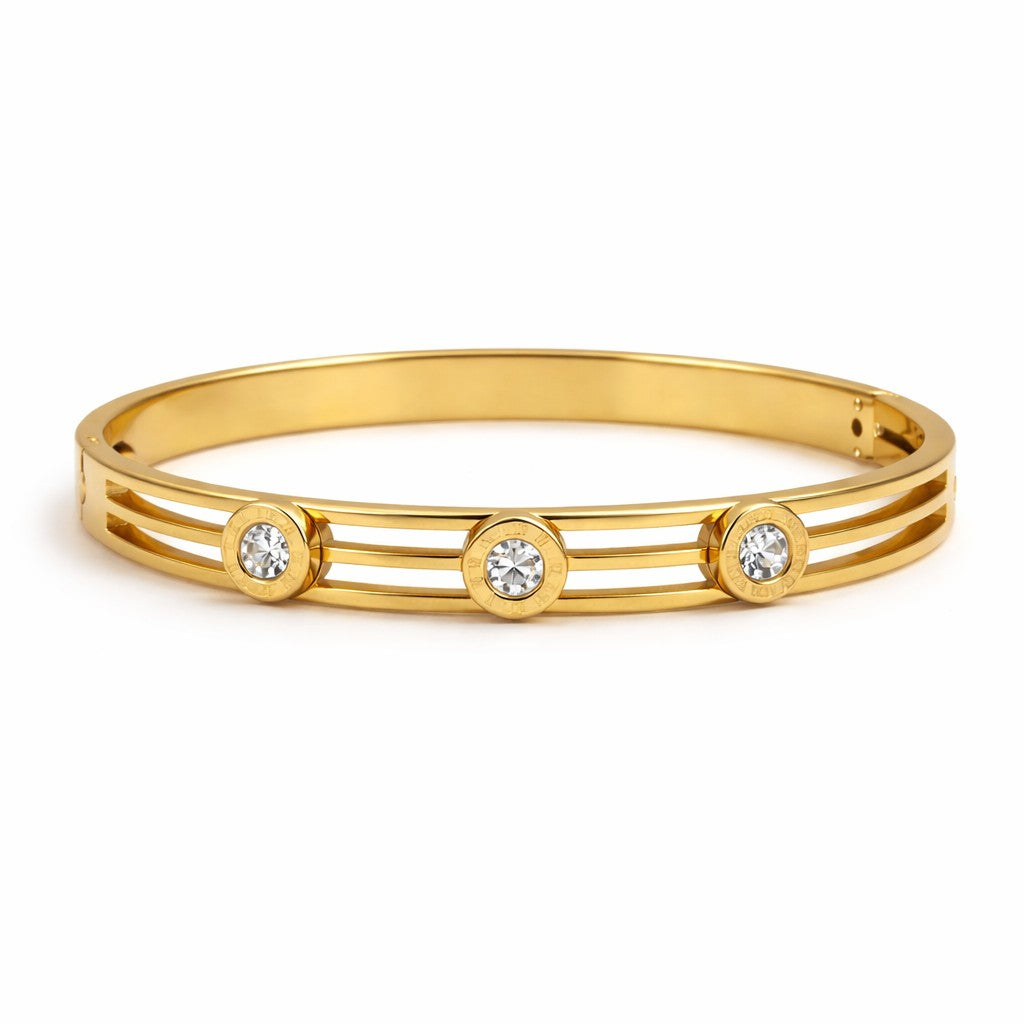 Front view of artificial bangles with gold-tone cuff design and three stone accents
