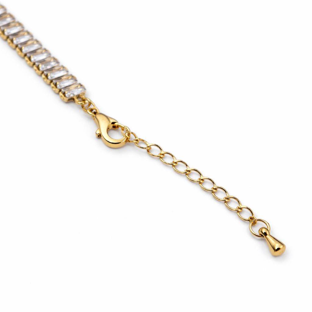 Chain detail of bracelet with polished gold-tone finish and stone setting