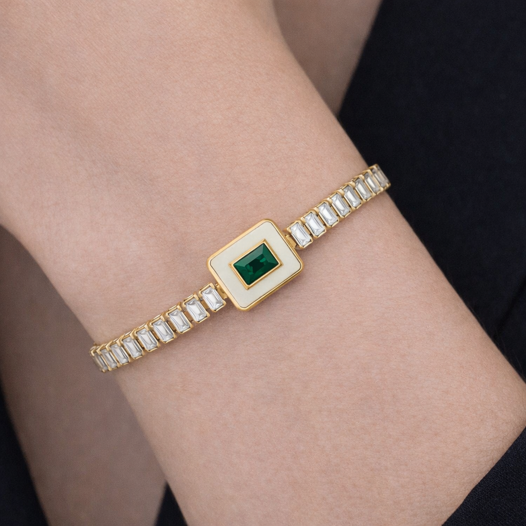 Close-up of bracelets for women with white stones and emerald centrepiece on wrist