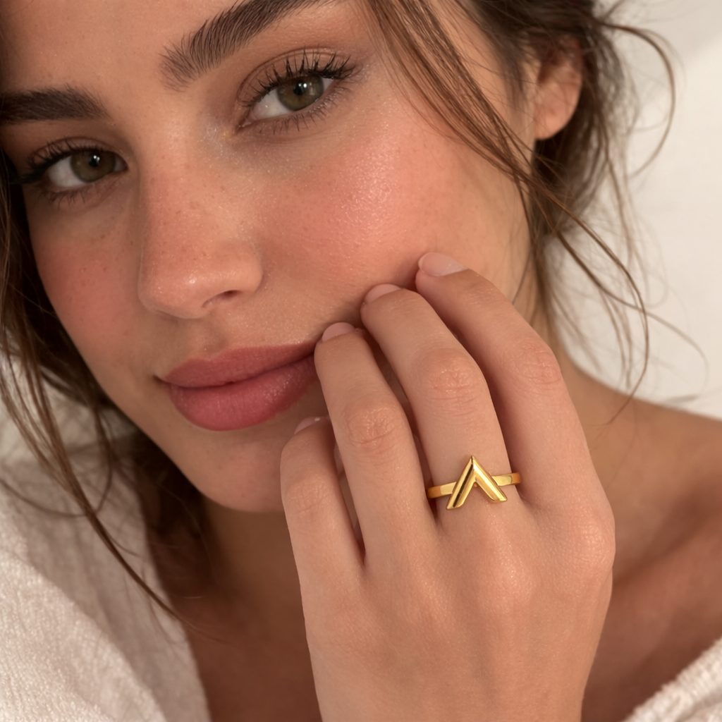 Model wearing gold V design statement ring
